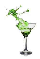 Splash in glass of a green alcoholic cocktail drink