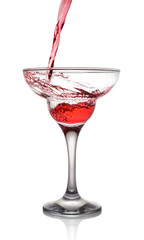Splash in glass of a pink alcoholic cocktail drink