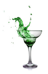 Splash in glass of a green alcoholic cocktail drink