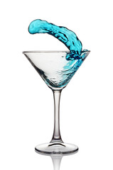 Splash in glass of a blue alcoholic cocktail drink
