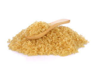 Wooden scoop spoon of brown cane sugar with pinch of sugar spilled around isolated on white...