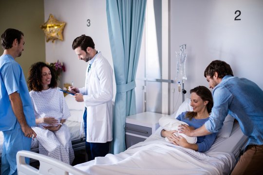Couple with their newborn baby in the ward