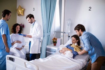 Fototapeta na wymiar Couple with their newborn baby in the ward