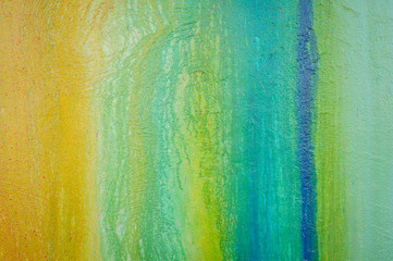 Part of a stone wall with colorful paint marks, paint texture, paint sprayed wall with colorful stains and flowing paint
