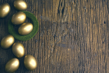 gold eggs on wood texture ground