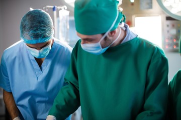 Fototapeta na wymiar Medical team performing operation in a operating room