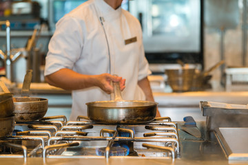 chef cooking with pan in the kitchen