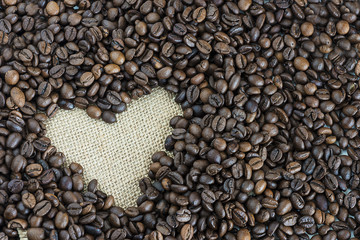heart of coffee beans on a sackcloth background