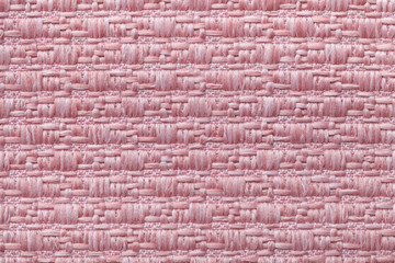 Pink knitted woolen background with a pattern of soft, fleecy cloth. Texture of textile closeup.