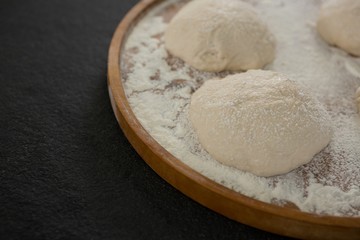Bread dough ball on wooden tray
