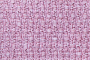 Pink knitted woolen background with a pattern of soft, fleecy cloth. Texture of textile closeup.