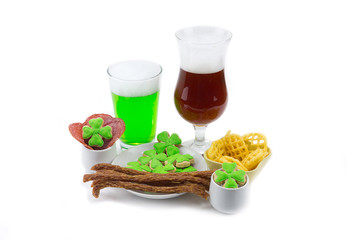 Meat snack two glasses of beer green amber dark with clover. The day of St. Patrick