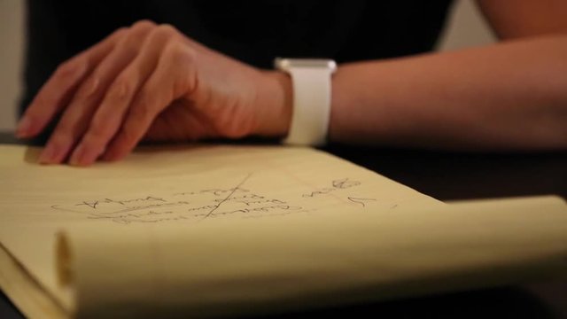 Female crossing written text with pen