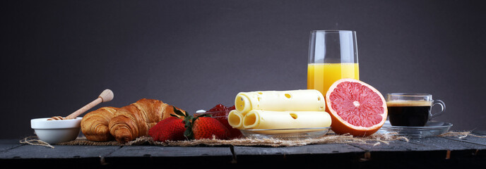 breakfast on table with waffles, croissants, coffe and juice - obrazy, fototapety, plakaty