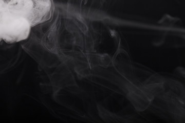 Cloud of smoke on black background. Selective focus