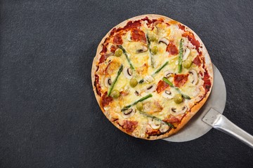 Italian pizza placed on a spatula