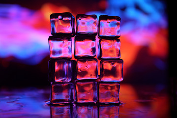 Ice cube on colourful background