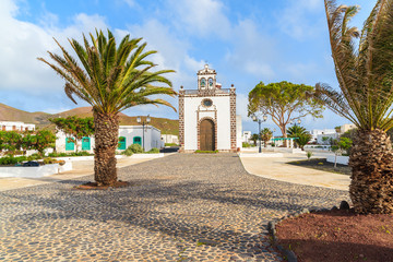 Square with palm trees and typical church in Guatiza village on Lanzarote, Canary Islands, Spain