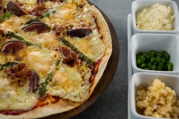 Italian pizza served with ingredients on a pizza tray