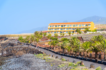 View of coastal promenade and apartment building in San Juan town, Tenerife island, Spain