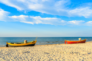 Fototapeta premium Colorful fishing boats on sandy Debki beach during sunny summer day, Baltic Sea, Poland