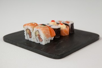 Maki, uramaki and nigiri sushi served in black stone slate