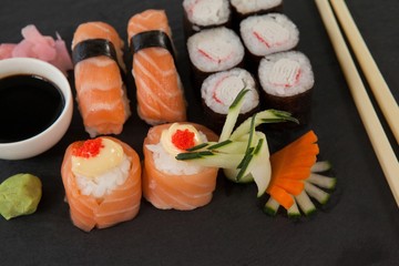 Set of assorted sushi served on black slate 