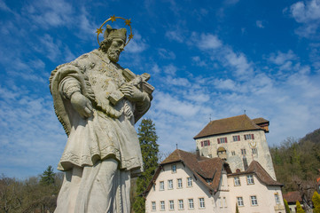 Fototapeta na wymiar Statue of John of Nepomuk with the Castle Rotwasserstelz in the background , Hohentengen, Germany 