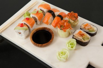 Assorted sushi set served with soy sauce on white board