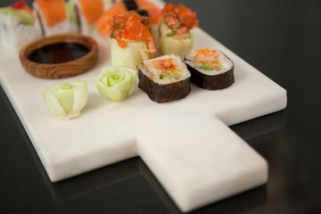 Assorted sushi set served with soy sauce on white board