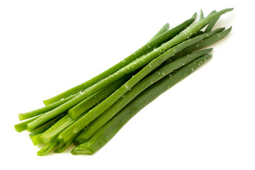 green leaves of onions on white