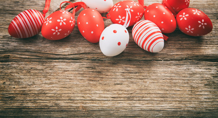 Colorful Easter eggs and copy space on wooden background