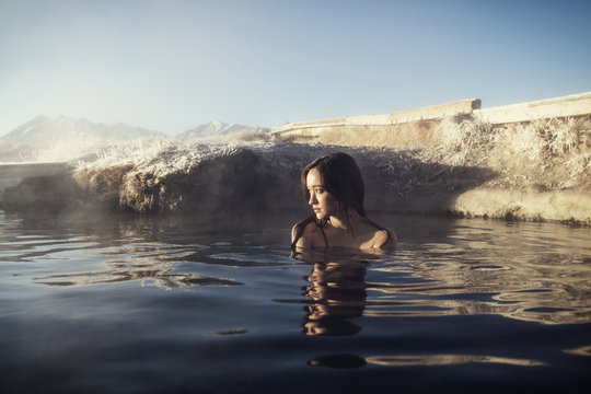 Mid-adult woman relaxing in hot spring