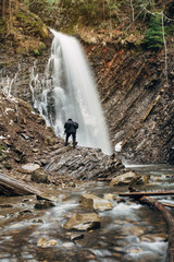 photographer photographing rock waterfal