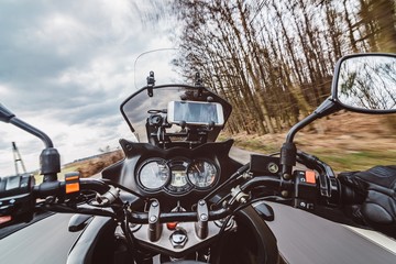 Driving a motorcycle at spring at the asphalt road