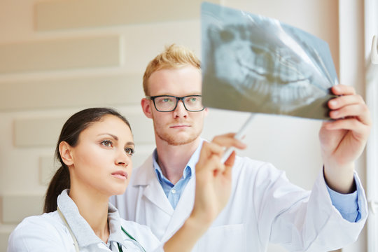 Zwei Zahnärzte analysieren Röntgenbild