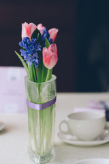 Cup and bunch of flowers