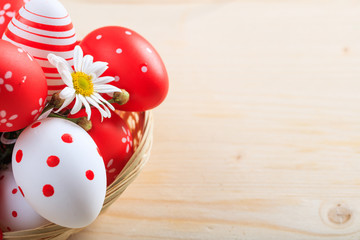 Colorful Easter eggs and copy space on wooden background