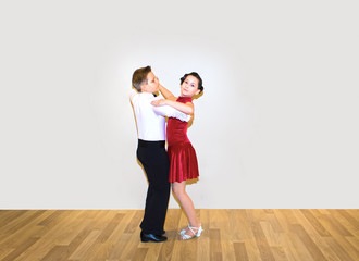 The young boy and girl posing at dance studio