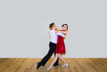 The young boy and girl posing at dance studio