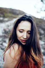 Fototapeta premium A girl in a red dress is lost in the woods