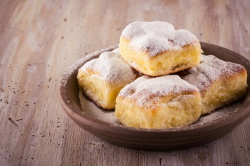 Few Homemade traditional cakes filled by curd on wooden board