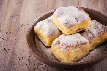 Several Homemade traditional cakes filled by curd on wooden board