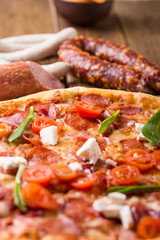 Rustic pizza with salami, mozzarellabasil top view with copy space. Two pizzas on a wooden table.  Pizza salami with tomatoes and olives. Pizza and coke. Salami and sausages