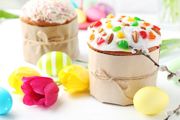 Easter eggs with cake on a white wooden table