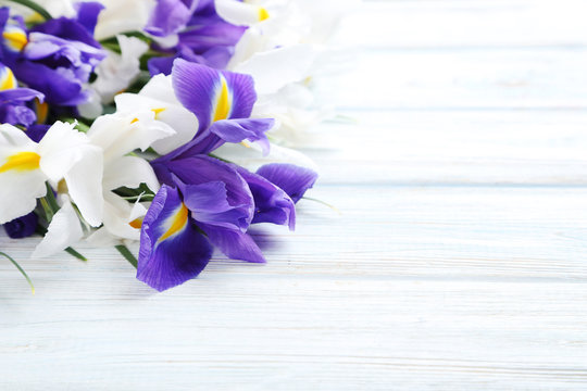 Bouquet of iris flowers on white wooden table