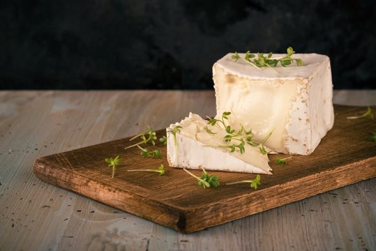 Unusual Camembert cheese with cube shape and green cress