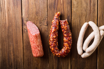 Homemade sausages on a wooden background. Sausages. White sausages. Sausages and salami.