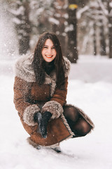 young beautiful walks in the Park, playing with snow