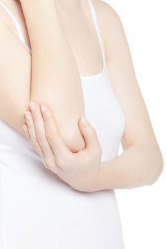 Young woman torso with hand holding elbow in pain isolated on white, clipping path
